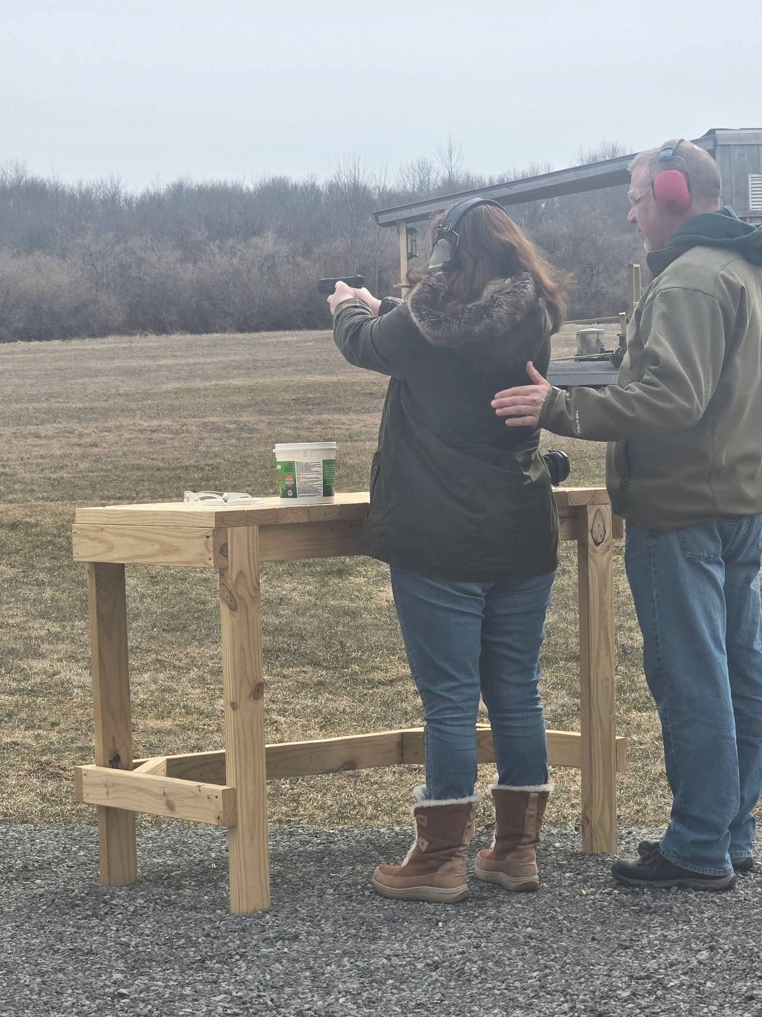 Ethan coaching a student through a live-fire string on the range