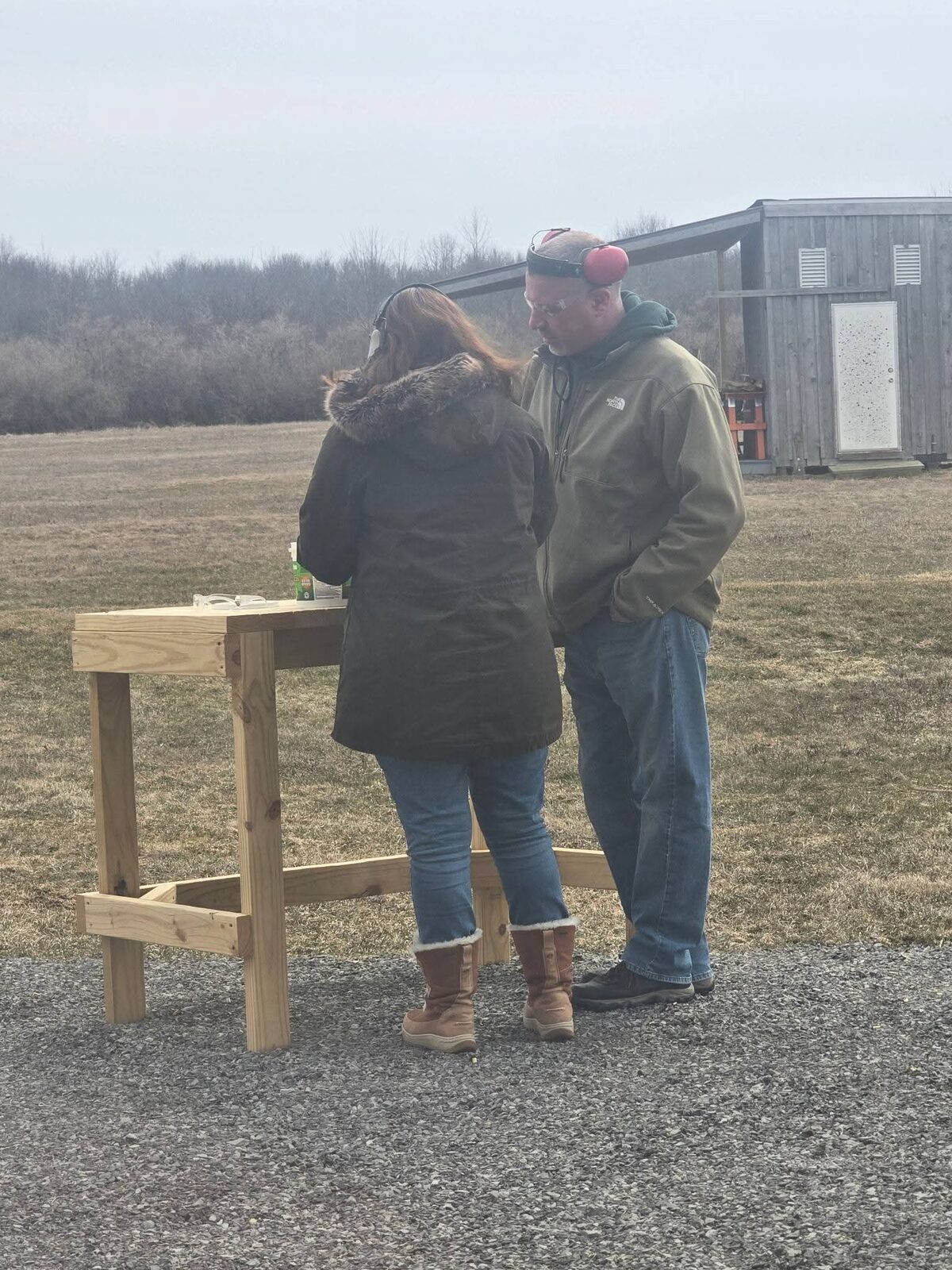 Ethan coaching a shooter one-on-one at the outdoor range